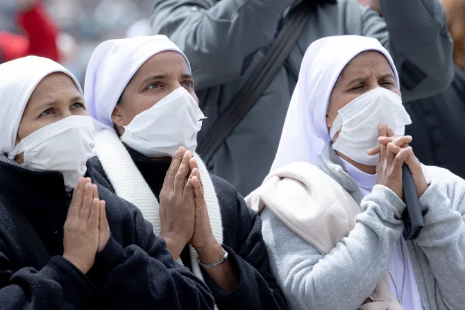 Religious sisters pray in St. Peter's Square while wearing COVID-19 masks on May 2, 2021.
